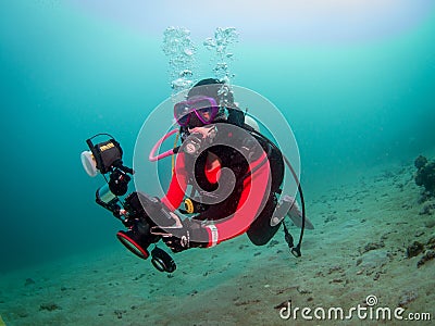 Scuba diver doing underwater photography in Anilao Philippines Editorial Stock Photo