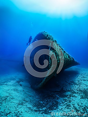 Scuba diver explores a sunken ship wreck Stock Photo