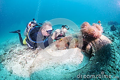 Scuba diver photographing corals Stock Photo