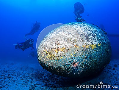 SCUBA divers explore the wreck of an aircraft Stock Photo