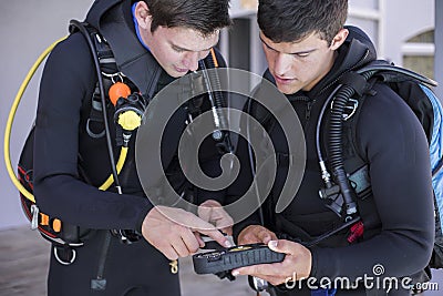 Scuba divers kitting up and checking their gear Stock Photo