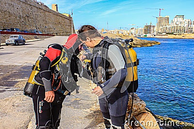Scuba divers performing an equipment check before diving. Editorial Stock Photo