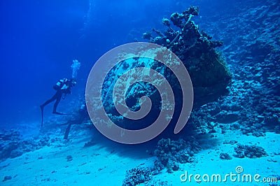 Scuba divers at underwater wreck Stock Photo