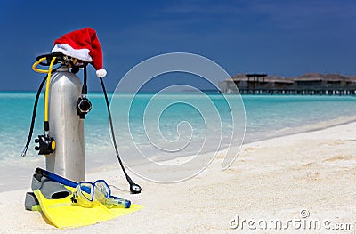 Scuba diving gear with a christmas hat on a beach Stock Photo