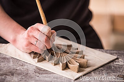 The sculptor creates a bas-relief. Plaster workshop. Close up. Selective focus Stock Photo