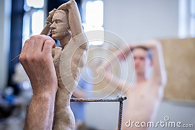 The sculptor sculpts a man`s sculpture from nature. Horizontal frame Editorial Stock Photo