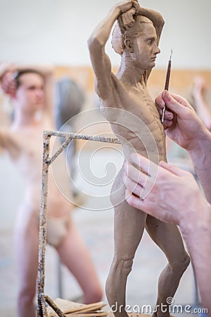 The sculptor sculpts a man`s sculpture from nature. Vertical frame Stock Photo