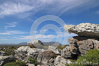 Sculptural boulder formation with distant mountain view Stock Photo