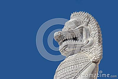 Sculpture of ancient white stone singha statue isolated on blue sky Editorial Stock Photo