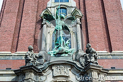 Sculpture of Angel killing a devil in front of Church of St. Michael, Hamburg, Germany. A landmark of the city and it is Stock Photo