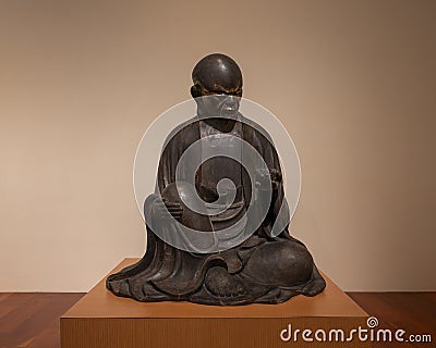 Sculpture of an Arhat from the 1615-1700 Edo period on display in the Dallas Museum of Art. Editorial Stock Photo