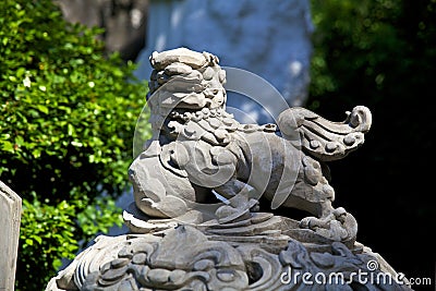 Sculpture of an Asian lion carved from stone in one of the ancient temples of Vietnam Stock Photo