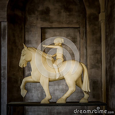 Sculpture of child riding a horse Editorial Stock Photo