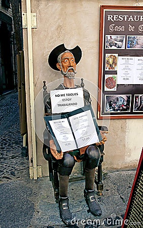 Sculpture of Don Quixote keeps the menu in front of the restaura Editorial Stock Photo