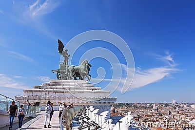 Sculpture Goddess Victoria riding on quadriga ,against the scenic panorama of the city of Rome . Roof of Altar of the Fatherland Editorial Stock Photo