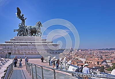 Sculpture Goddess Victoria riding on quadriga ,against the scenic panorama of the city of Rome . Roof of Altar of the Fatherland Stock Photo