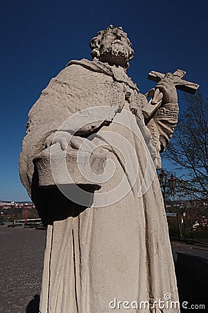 Sculpture of holy man with cross and basket, originally placed on bridge to castle Nitra, Slovakia. Stock Photo
