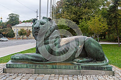 Sculpture of a lion, located near the Temple-monument of Alexander Nevsky. View of the streets of the city and the Editorial Stock Photo