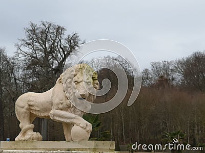 Sculpture of a lion of Medici with a ball in the paw in the park National Domain of Saint Cloud Stock Photo