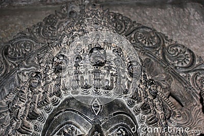 Sculpture with micro carved hallow skull at Hoysaleswara Temple Stock Photo