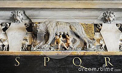 Sculpture of the mythical she-wolf suckling the infant twins Romulus and Remus. Roman symbol SPQR, Italian architecture detail. Editorial Stock Photo