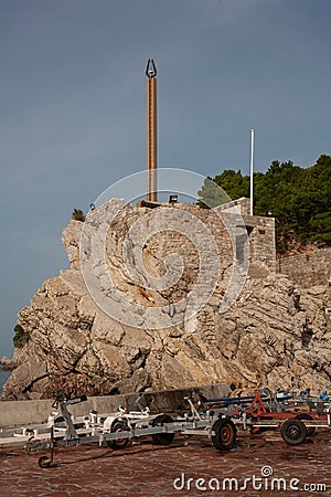 Sculpture on a rocky cliff at the shore in Petrovac Editorial Stock Photo