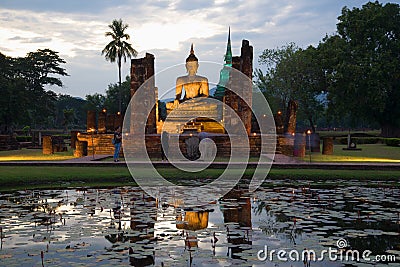 The sculpture of a seated Buddha in the twilight. Sukhothai, Thailand Editorial Stock Photo