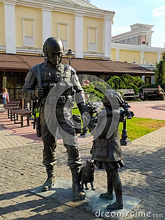 A sculpture of a soldier in camouflage and a girl with a cat, polite people, in Simferopol, Crimea. Travel concept. Mobile photo Editorial Stock Photo