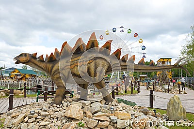 Sculpture of a stegosaurus close-up on a cloudy day. `Yurkin Park` - children`s themed entertainment park Editorial Stock Photo