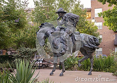 Sculpture of a trail boss cowboy sitting on a horse by Robert Summers in Plano, Texas. Editorial Stock Photo