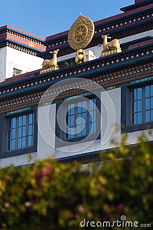 Sculpture of two deer and dharmachakra on a roof of monastery. Stock Photo