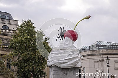 Sculpture of whipped cream with red cherry and drone as a fly Editorial Stock Photo