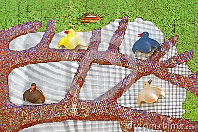 Sculptured panel of a tree with colorful crows by the sculptor Constantin Skretutsky at Pejzazhna alley Editorial Stock Photo