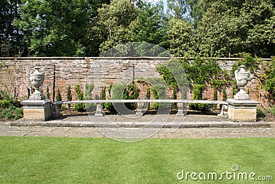 Sculptured stone seat or bench with lidded urns Stock Photo