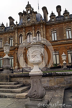 Sculptured urns on pedestals in front of domed sculptured facade with columns Stock Photo