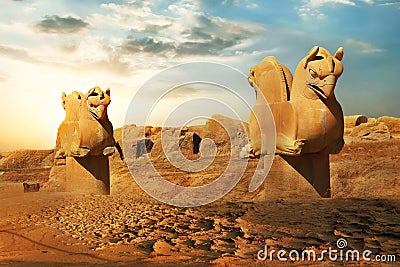 Sculptures of griffins in ancient Persepolis against the backdrop of the rising sun. Iran. Stock Photo