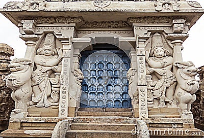 The sculptures of mythological creatures and gods at the entrance to an ancient Indian temple Stock Photo