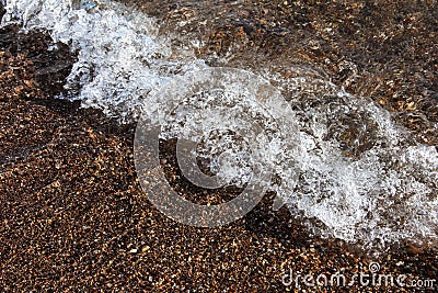 Sea background. Waves on the background of pebbles. Seashore Stock Photo