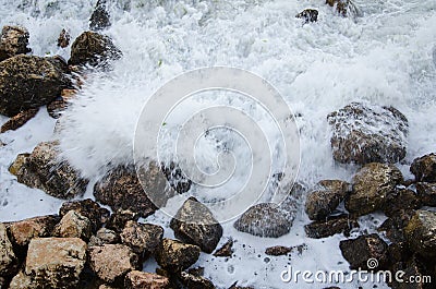 Seascape, seafoam of storm on wild rocky seashore Stock Photo