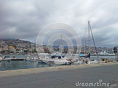 Sea bay with yachts and boats at cloudy day in San Remo, Italy, view from city Sanremo, Italian Riviera Stock Photo