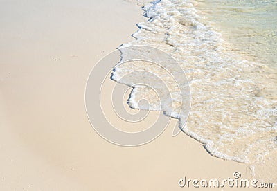 Sea beach with smooth wave photo background. Coral beach sand with sea tide. Stock Photo