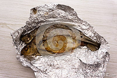 Sea Bream fish baked in foil with lemon and a sprig of thyme Stock Photo