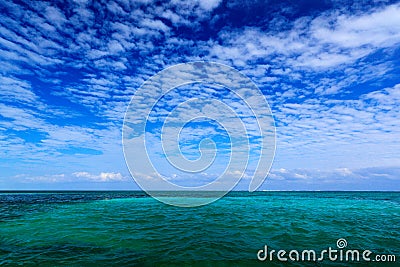 Sea in Caribbean with blue sky and white cloud. Water surface in ocean. Beautiful morning twilight sea landscape. Pink clouds with Stock Photo