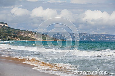 The sea coast of Bulgaria is a sandy beach with Golden sand and rocky high banks with tiled roofs of houses. Stock Photo