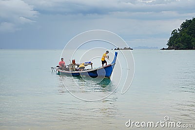 Local Asian fisherman boat on the sea with low floating clouds. Editorial Stock Photo