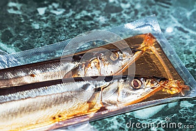 Sea fish saury in vacuum packaging Stock Photo