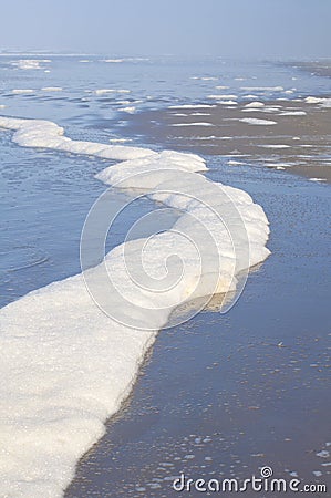 Sea foam wave on ocean beach Stock Photo