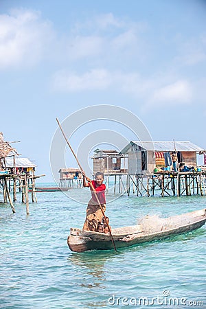 Sea Gypsy Woman paddling her sampan with her kids Editorial Stock Photo