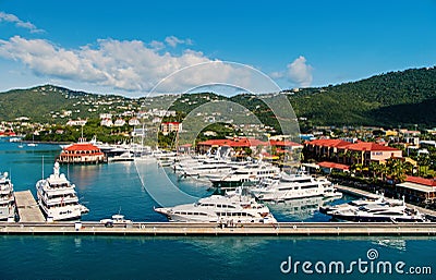 Sea port and town on sunny blue sky. Yachts moored at sea pier on mountain landscape. Luxury travel on boat, water Editorial Stock Photo