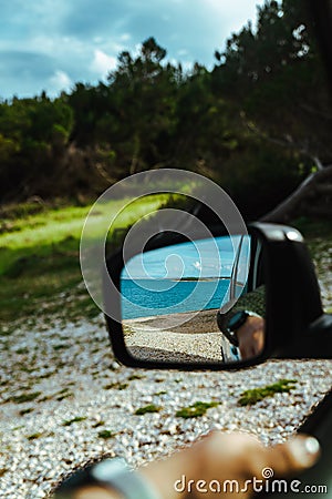 sea reflection in car rear mirror. road trip Stock Photo